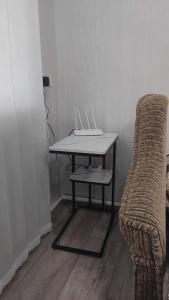 a table and a chair in a room at Котэдж Посуточно in Zhovti Vody