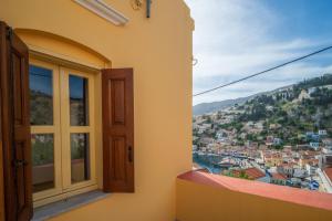 a window with a view of a city at Panoramic View House in Symi +35 photos