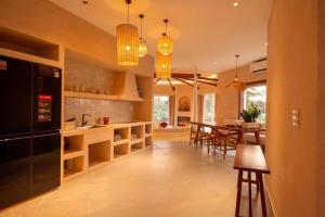 a kitchen and dining room with pendant lights at QUEEN VILLA - Hoa Tiên paradise in Ðông Hội