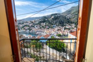 a view of a city from an open window at Panoramic View House in Symi