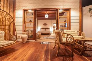 a living room with a bed and a table and chairs at The Lost Island- Luxury Private Pool Villas in Gili Trawangan