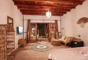 a bedroom with a bed and a living room at The Lost Island- Luxury Private Pool Villas in Gili Trawangan