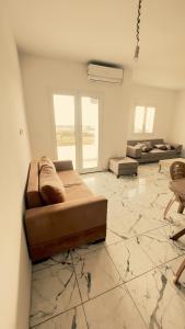 a large living room with a couch and a table at Appartements de rêve in Hennchir Ksar Rhaleb +39 photos