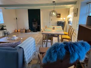 a living room with a table with a blue rug at Boots and Bikes B&B in Neksø +24 photos