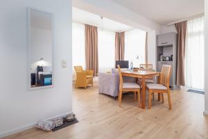 a dining room and living room with a table and chairs at Strandläufer in Thiessow