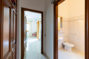 a bathroom with a toilet and a sink at Tavolara Ichnos House in San Teodoro +33 photos