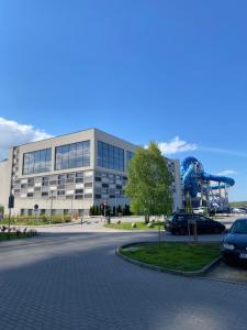 a large building with a large sculpture in front of it at Apartament AquaTower, Aquapark Reda in Reda