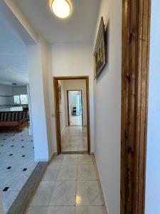 a hallway with a door and a tile floor at Villa Pieds dans l eau entre Lagune et Montagne in Ghār al Milḩ