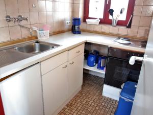a kitchen with a sink and a stove at Ferien- & Freizeitpark Grafenhausen in Grafenhausen +62 photos