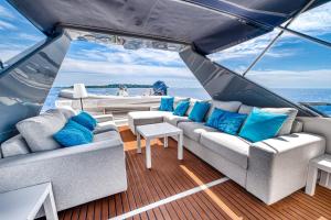 a living room on a boat with blue pillows at Yacht FALCON FIVE in Cannes