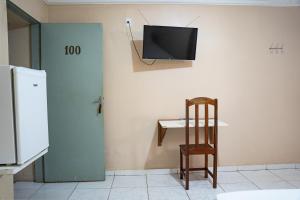 a room with a chair and a tv on the wall at Porto Seguro Hotel - Porto Velho in Porto Velho +27 photos