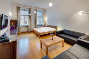 a living room with a couch and a table at Selinor Old Town Apartments in Prague