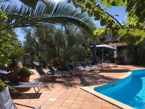 a swimming pool with lounge chairs and a swimming pool at Villa Monica appartamenti in Vieste