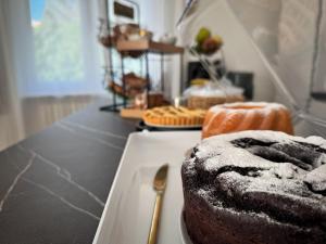 a chocolate cake on a white plate with a fork at Maison Trentasette in Potenza