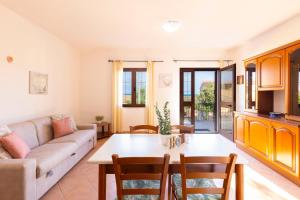 a living room with a couch and a table at Molara Ichnos House in San Teodoro