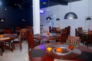 a dining room with wooden tables and chairs at minidu resort in Ambalantota