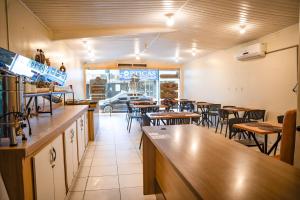 a dining room with tables and chairs in a restaurant at Porto Seguro Hotel - Porto Velho in Porto Velho