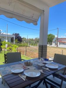 a table with plates of food on a patio at Ariana's apartment in Orfánion