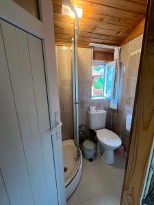 a small bathroom with a toilet and a sink at Naz Apartlari Cirali in Cıralı +94 photos