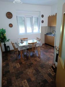a kitchen with a table and chairs in a room at Rooms-Sema in Mostar