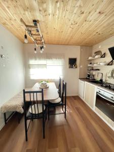 a kitchen with a table and chairs in a room at Holiday home Metulum in Oštarije
