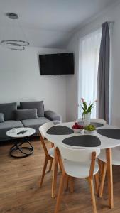 a living room with a table and a couch at Apartament DobraNocka in Ściegny