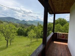 a porch of a house with a view of the mountains at La Paramon ! in Sângeorz-Băi
