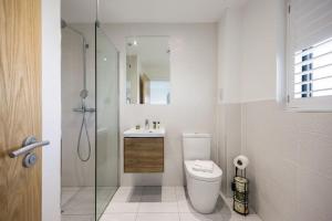 a bathroom with a toilet and a sink and a shower at Jurassic in Dorchester