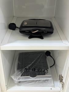 a black printer sitting on a shelf in a drawer at روز للاستديوهات المفروشة in Abu Dhabi +3 photos