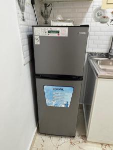 a refrigerator in the corner of a kitchen at روز للاستديوهات المفروشة in Abu Dhabi