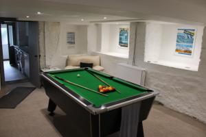 a living room with a pool table in a room at Ty Clyd in Pembrokeshire