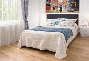 a bedroom with a bed with a white comforter at Villa Marguerite in Coutras +24 photos
