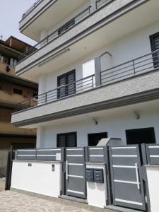 a house with metal gates in front of it at Sea and Airport View in Fiumicino