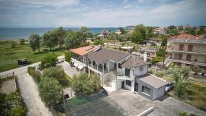 an aerial view of a house with the ocean at Iraklia Coral in Nea Irakleia