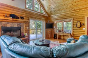 a living room with a leather couch and a fireplace at Heaven's Gate in Durango