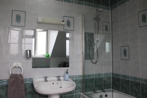 a bathroom with a sink and a shower at Ty Clyd in Pembrokeshire +28 photos
