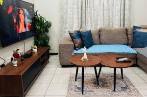 a living room with a couch and a table at Brilliant Home in Gaborone