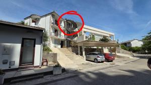a red circle is on the side of a house at Apartment Tara in Igalo