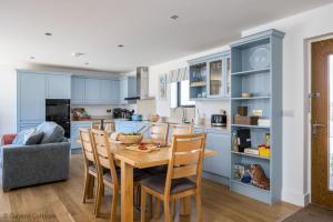 a kitchen with a wooden table and chairs at Dawn Lighthouse in Dorchester