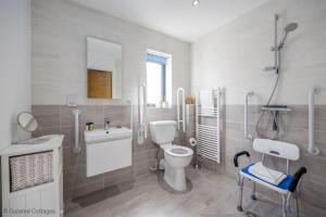 a bathroom with a toilet and a sink and a mirror at Dawn Lighthouse in Dorchester
