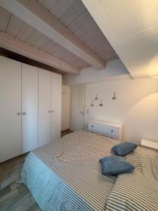 a bedroom with a bed with two pillows on it at Residence Fortuna - Appartamento Gori in Fano