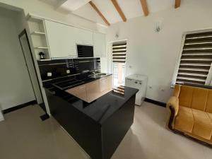 a kitchen with a black counter top and a couch at Vila Tigani in Peje +8 photos