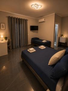 a bedroom with a large bed and a tv at Reale Mountain View in Mascalucia