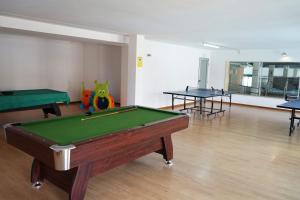 a room with a pool table and two tables at PLAYASDEBARREIROs in San Miguel de Reinante