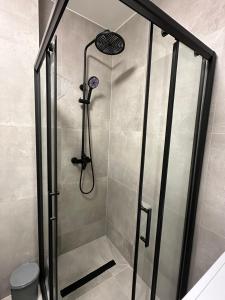 a shower with a glass door in a bathroom at Golden Nest in Tuzla
