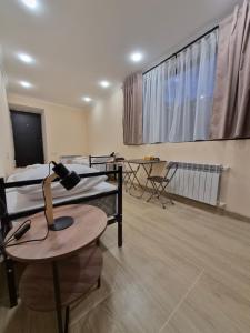 a room with three bunk beds and a table with a lamp at Noosh Ashnak guesthouse in Ashnak