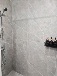 a bathroom with a shower with gray tiles at Noosh Ashnak guesthouse in Ashnak +31 photos