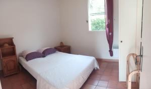 a bedroom with a white bed and a window at La Villa des Restanques in Carry-le-Rouet +8 photos
