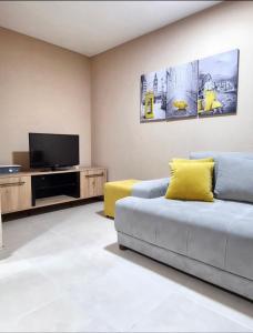 a living room with a couch and a tv at Apartman Avram in Kotor-Varoš