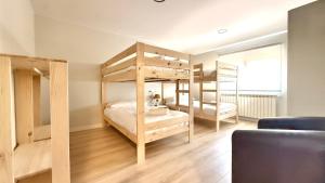 a bedroom with two bunk beds and a couch at Apartamentos Pantón Ribeira Sacra in Ferreira +67 photos